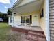 Inviting front porch with seating, showcasing the home's entrance and charming curb appeal at 40287 Palmerville Rd, New London, NC 28127