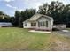 Quaint home with well-manicured lawn, mature trees, and a rustic outbuilding adding to the property's charm at 40287 Palmerville Rd, New London, NC 28127