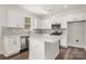 This eat-in kitchen features white cabinetry, stainless appliances, and a breakfast bar at 4037 Jenison Valley Ct, Charlotte, NC 28214