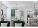 Open concept kitchen area with stainless steel appliances, dining table, and a view of the living room at 4038 Jenison Valley Ct, Charlotte, NC 28214