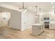 Open concept kitchen with island featuring modern appliances and white cabinets at 4038 Jenison Valley Ct, Charlotte, NC 28214