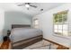 This bedroom showcases a queen-size bed, two windows, and a ceiling fan at 409 Lexie Ln, Rock Hill, SC 29732