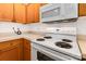Kitchen features wooden cabinets, white appliances, and a smooth countertop at 409 Lexie Ln, Rock Hill, SC 29732