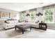Spacious living room featuring stylish sofas, patterned ottoman, and ample natural light at 497 Lenswood Ct, Denver, NC 28037