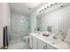 Modern bathroom featuring a double vanity, a walk-in shower, and marble accents at 5005 Chestnut Knoll Ln, Charlotte, NC 28269