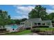 Charming clubhouse with a covered porch next to a pool, with well-maintained landscaping and inviting atmosphere at 5005 Chestnut Knoll Ln, Charlotte, NC 28269