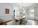 Elegant dining room with hardwood floors, neutral decor, stylish lighting, and seating for six at 5005 Chestnut Knoll Ln, Charlotte, NC 28269
