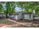 Rear exterior view of home with gray siding, yard, and partial fencing at 5143 Delivau Dr, Charlotte, NC 28215