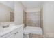 Bathroom featuring a tiled shower, a vanity with a sink, and a toilet at 5143 Delivau Dr, Charlotte, NC 28215
