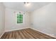 Cozy bedroom with hardwood floors and a window overlooking the backyard at 5143 Delivau Dr, Charlotte, NC 28215
