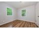 Bedroom with hardwood floors and large windows, providing ample natural light at 5143 Delivau Dr, Charlotte, NC 28215