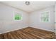 Bedroom with hardwood floors and large windows, offering plenty of natural light at 5143 Delivau Dr, Charlotte, NC 28215