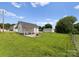Expansive backyard featuring a shed with a covered patio, a hammock, and a fire pit at 515 N Main Gq St, Granite Quarry, NC 28146