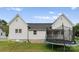 Backyard view of house with trampoline and screened porch at 515 N Main Gq St, Granite Quarry, NC 28146