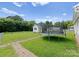 Spacious backyard with lush green grass, a trampoline, and a charming shed at 515 N Main Gq St, Granite Quarry, NC 28146