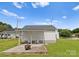Cozy backyard featuring a shed with a covered patio, seating, and a fire pit at 515 N Main Gq St, Granite Quarry, NC 28146