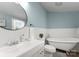 Bright bathroom with wood floors, a soaking tub, white cabinets, and plenty of natural light at 515 N Main Gq St, Granite Quarry, NC 28146