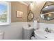 Charming bathroom featuring dual sinks, decorative mirrors, and wainscoting at 515 N Main Gq St, Granite Quarry, NC 28146