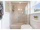 Bright bathroom showcasing a glass-enclosed shower and neutral tile and paint at 515 N Main Gq St, Granite Quarry, NC 28146