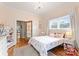 Bright bedroom featuring wood floors, a large window, and charming decor perfect for a space at 515 N Main Gq St, Granite Quarry, NC 28146