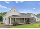Well-maintained exterior with charming porch and manicured lawn at 515 N Main Gq St, Granite Quarry, NC 28146