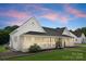 Charming exterior view of home with front porch, manicured lawn, and colorful sky at 515 N Main Gq St, Granite Quarry, NC 28146
