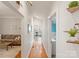 Bright hallway with wood floors, light walls, and open views to both the living room and kitchen at 515 N Main Gq St, Granite Quarry, NC 28146