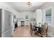 Bright kitchen with stainless appliances, white cabinets, and a cozy dining nook with a round table at 515 N Main Gq St, Granite Quarry, NC 28146