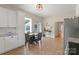 Eat-in kitchen features tiled floors, a dining table, and ample cabinet and counter space at 515 N Main Gq St, Granite Quarry, NC 28146
