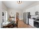 Bright eat-in kitchen with stainless appliances, tile flooring, and backyard access at 515 N Main Gq St, Granite Quarry, NC 28146