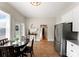 Sunlit eat-in kitchen features stainless appliances, tiled floors, and backyard access at 515 N Main Gq St, Granite Quarry, NC 28146