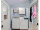 Functional laundry room with modern appliances, ample storage, and a vintage-style door at 515 N Main Gq St, Granite Quarry, NC 28146