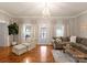 Bright living room with hardwood floors, neutral furnishings, and a decorative chandelier at 515 N Main Gq St, Granite Quarry, NC 28146