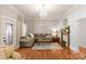 Inviting living room with wood floors, neutral walls, an elegant chandelier, and a comfortable sectional sofa at 515 N Main Gq St, Granite Quarry, NC 28146