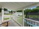 Inviting covered porch with white railings, wood flooring, and view of a large trampoline at 515 N Main Gq St, Granite Quarry, NC 28146