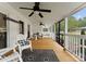 Inviting screened porch with comfortable seating, ceiling fans, and stylish decor at 515 N Main Gq St, Granite Quarry, NC 28146