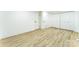 Neutral bedroom boasts light hardwood floors and multiple closet doors for ample storage at 5226 Fair Wind Ln, Charlotte, NC 28212