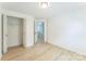 Bedroom features a closet, light hardwood floors and open door to the staircase at 5226 Fair Wind Ln, Charlotte, NC 28212