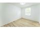 Minimalist bedroom showcasing a window that fills the room with natural light and hardwood floors at 5226 Fair Wind Ln, Charlotte, NC 28212