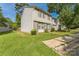 Charming townhouse with a well-manicured lawn and mature trees on a sunny day at 5226 Fair Wind Ln, Charlotte, NC 28212