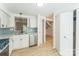 Updated kitchen features stainless steel appliances, light countertops and blue backsplash at 5226 Fair Wind Ln, Charlotte, NC 28212