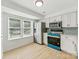 Bright kitchen featuring stainless steel appliances, white cabinets and wood-look flooring at 5226 Fair Wind Ln, Charlotte, NC 28212