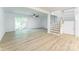 Open living area with wood-look floors, fan, and access to outdoor space at 5226 Fair Wind Ln, Charlotte, NC 28212