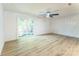 Spacious living room features sliding glass door and ceiling fan at 5226 Fair Wind Ln, Charlotte, NC 28212