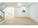 Inviting living area with wood-look floors, staircase, and a peek into the kitchen at 5226 Fair Wind Ln, Charlotte, NC 28212