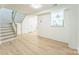 Bright and open living space featuring wood-look floors and a staircase at 5226 Fair Wind Ln, Charlotte, NC 28212