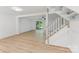 Open-concept living area with wood-look flooring and staircase at 5226 Fair Wind Ln, Charlotte, NC 28212