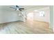 A bright living room featuring wood-look flooring and a staircase at 5226 Fair Wind Ln, Charlotte, NC 28212