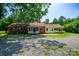 Backyard view of home with brick exterior, screened-in porch, and carport at 7016 Tirzah Rd, Waxhaw, NC 28173