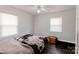 Bedroom featuring hardwood floors, bright windows, light walls, and a statement bedspread at 7016 Tirzah Rd, Waxhaw, NC 28173